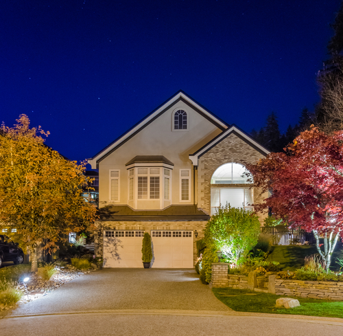 house at night with landscape lighting