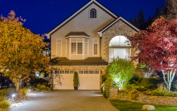 House with landscape lighting for security